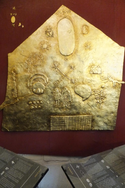 Gold Incan plate featuring religious symbols. 
